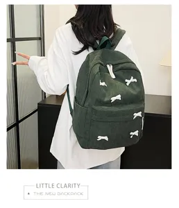 Detailed view of the Japanese style corduroy backpack featuring cute white bow accents for girls.