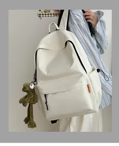 Casual large capacity solid color backpack for students, stylish minimalist school bag with pendant.
