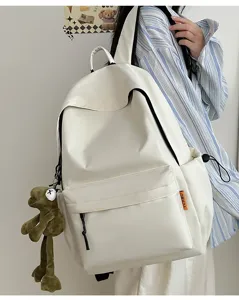 Minimalist solid color large capacity school backpack featuring a cute frog pendant.