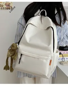 Minimalist large capacity solid color backpack casual school bag with cute frog plush pendant.