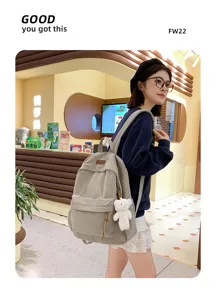 Large capacity corduroy backpack with cute bear pendant, trendy school bag for women daily travel.