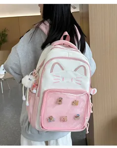 Pink and white cat ita bag cute backpack with transparent mesh pocket and fluffy pendant.