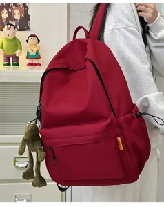 Minimalist solid color large capacity backpack for school travel and daily casual use red style.