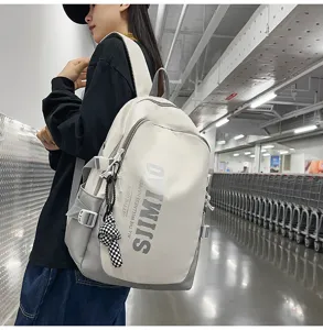 Detail shot of a large-capacity campus backpack in grey and white with stylish print.
