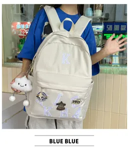 Detailed view of casual canvas backpack with letter embroidery and cute cloud pendant for daily use.
