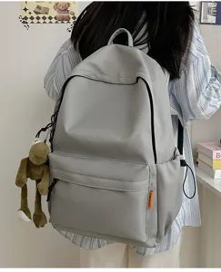 Detailed view of minimalist solid color backpack, large capacity casual school bag for daily use.