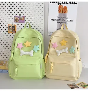 Detailed view of minimalist student backpack with cute plush star and bone charms, versatile design.
