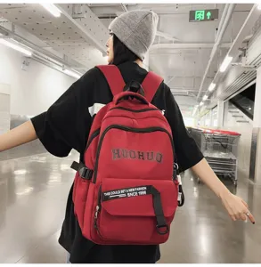 Vintage canvas backpack, large capacity school bag for students, casual daypack in red.