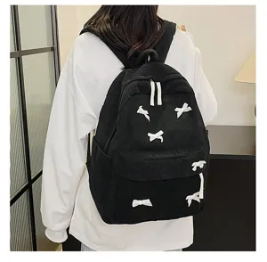 Black corduroy backpack with cute white bow details, casual daily bag for students and teens.