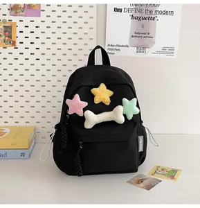 Casual black student backpack with cute plush star and bone charms, stylish daily daypack.