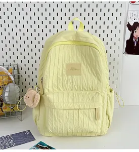Casual solid color pleated backpack for women, lightweight school bag for travel and daily use.