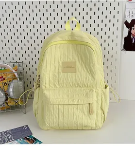 Solid color lightweight small backpack for daily travel and school use, yellow bookbag.