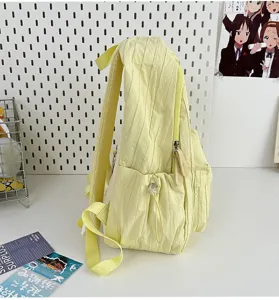 Solid color lightweight backpack for daily casual use, school, and travel in light yellow.