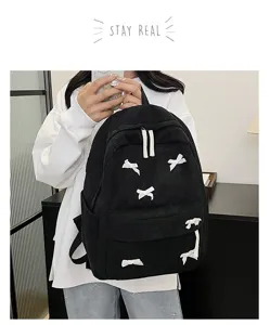 Detailed view of black corduroy backpack with cute white bows, casual style for daily wear.