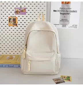 Detailed view of the minimalist student canvas backpack with front pocket and shoulder straps.