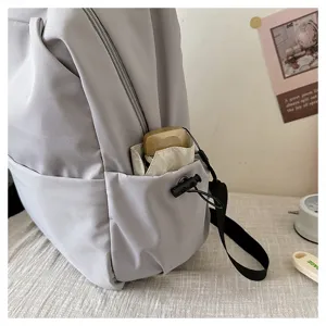 Casual solid color large capacity backpack side pocket detail view showing daily utility.