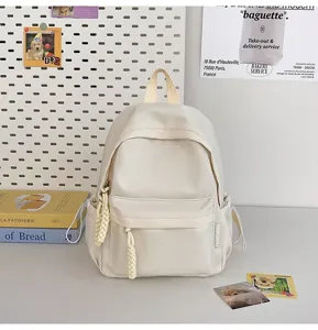 Minimalist solid color student backpack detail view, casual style everyday mini bag for school.