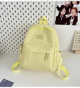 A stylish solid color yellow casual backpack lightweight travel school bag for daily use