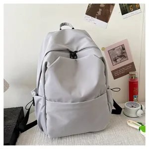 Solid color large capacity casual backpack school bag for daily commuting and student use.