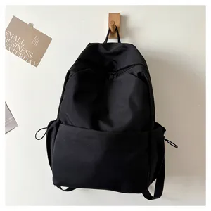 Minimalist black backpack for daily commuting, large capacity casual school bookbag.