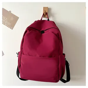 Close up view of solid color casual backpack showing durable fabric and shoulder straps details.