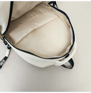 Retro college style casual backpack detail showing large capacity interior and zipper compartments bag.