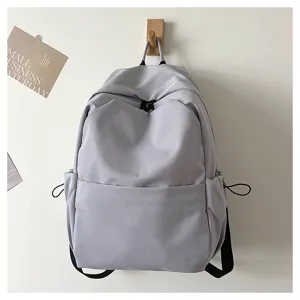 Solid color grey casual backpack detail, minimalist design with front pocket and shoulder strap.