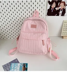 Detailed view of the pink pleated lightweight casual backpack for girls and students daily use.