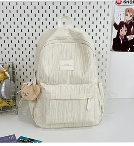 Solid color pleated backpack detail view, casual lightweight school bag for daily travel.