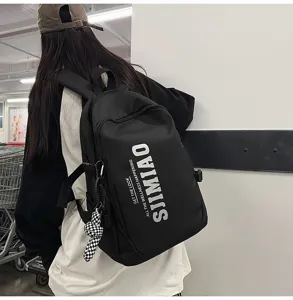 Black canvas backpack large capacity laptop school bag for students commuter daily use.