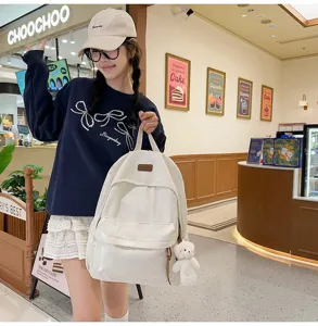 White corduroy backpack for women, casual daily school bookbag with cute bear pendant.