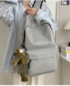 Detail view of large capacity minimalist solid color casual school backpack for students.