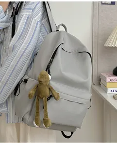 Minimalist large capacity solid color backpack with cute frog pendant for daily school use.