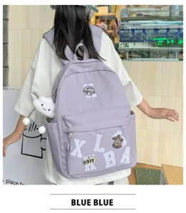 Detailed view of casual purple canvas backpack with letters badge and cute cloud pendant.
