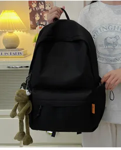 Minimalist solid color large capacity backpack detail, casual student school bag with cute pendant.