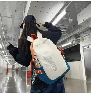 Detailed view of the stylish color-blocked canvas backpack in white, blue, and orange tones.