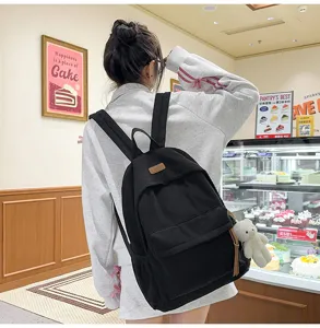 Black corduroy backpack for women, casual stylish school bag for students daily use.