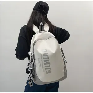 Detail shot of large capacity casual backpack with dual-tone grey design and side straps.