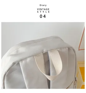 Detailed view of casual grey backpack top handle and strap design, durable everyday carry.