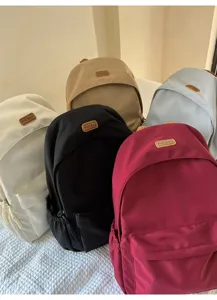 Detailed multi-color display of casual canvas backpacks with front pocket and contrast label design.