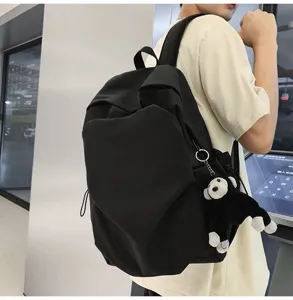 Casual black large capacity school backpack with cute monkey pendant for daily college student use.