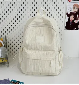 Solid color pleated backpack for women and students, lightweight casual travel school bag.