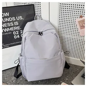 Solid color minimalist large capacity casual backpack detail showing zipper and fabric texture.