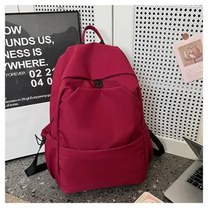 Solid color casual large capacity backpack for students daily commuting and travel use.