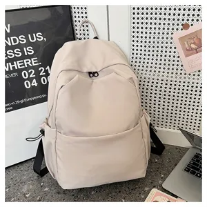 Detailed view of minimalist solid color backpack showing front pocket and side pockets.