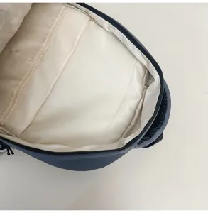 Interior compartment detail of the retro student casual backpack with spacious beige lining design.
