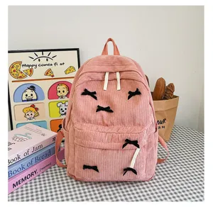 Pink corduroy backpack for women, cute school bookbag with black bows, Japanese style casual daypack.