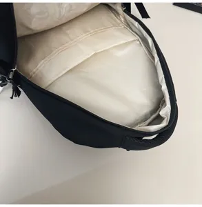 Detail view of the black backpack interior showing spacious compartments and lining.