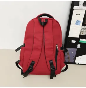 Detailed view of the red casual backpack showing back straps, durable fabric and side pocket.