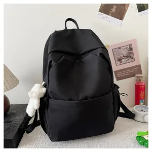 Solid black large capacity casual backpack detail, durable fabric, multiple compartments for school.